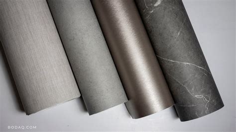 Rolls of Bodaq architectural film in fabric, concrete, metallic and marble finishes