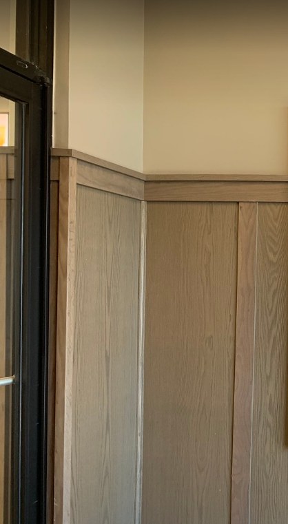 Restaurant entry with woodgrain wainscot paneling